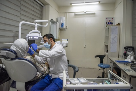 Dentist treating a patient in a clinic overseas
