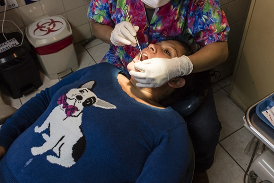 Dental professional treating a patient in a community clinic